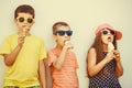 Kids boys and little girl eating ice cream. Royalty Free Stock Photo