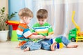 Kids boys play together with educational toys