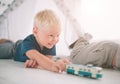 Kids brothers are laying on the floor. Boys are playing in home with toy cars at home in the morning. Casual lifestyle Royalty Free Stock Photo