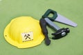 Kids builder toy set. Plastic yellow construction hard hat and tool kit hammer, saw and screwdriver Royalty Free Stock Photo