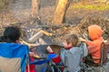 Kids burning a fire at camping ground Royalty Free Stock Photo