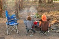 Kids burning a fire at camping ground Royalty Free Stock Photo
