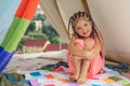 Kids camping. Having fun outdoors. Campground. Little girl with dreadlocks camp with tent. Child active lifestyle.