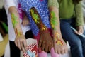 Kids brightly painted arms at a carnival