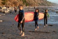 Kids carrying a long surfboard at Swami's Beach, Encinitas, Cardiff-by-the-Sea, on December 28, 2023 Royalty Free Stock Photo