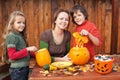 Kids carving jack-o-lanterns for Halloween