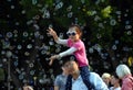 Kids catching and having fun and with soap bubbles