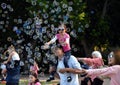 Kids catching and having fun and with soap bubbles