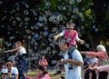 Kids catching and having fun and with soap bubbles