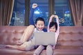 Kids cheering while operating a laptop at night Royalty Free Stock Photo
