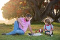 Kids chess school. Father and son playing chess lying on grass at lawn park. Fathers Day, love family, parenthood Royalty Free Stock Photo