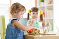 Kids children eating vegetables in kindergarten or at home