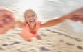 Kids, children and girl swinging on the beach while playing, laughing or having fun with a parent against the sand with