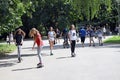 Kids or children are having fun in the park in summertime, skateboarding, riding bikes Royalty Free Stock Photo