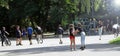 Kids or children are having fun in the park in summertime, skateboarding, riding bikes Royalty Free Stock Photo