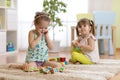 Kids playing with toy cubes in kindergarten room Royalty Free Stock Photo