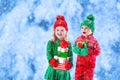 Kids with Christmas presents in winter park in snow Royalty Free Stock Photo