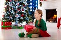 Kids at Christmas tree. Children open presents Royalty Free Stock Photo