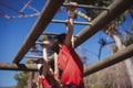 Kids climbing monkey bars during obstacle course training Royalty Free Stock Photo