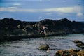 Kids climbing rock wall at The Tanks tourist attraction natural rock pool at Forster, New South Wales Australia Royalty Free Stock Photo