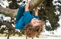Kids climbing trees, hanging upside down on a tree in a park. Child protection. Royalty Free Stock Photo