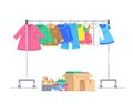 Kids clothes and shoes on hanger rack for donation Royalty Free Stock Photo