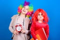 Kids colorful curly wig clown style hold alarm clock. I am not joking about discipline. School alarm. Girl worry about