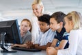 Kids in computer class with teacher Royalty Free Stock Photo