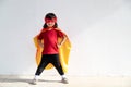 Kids concept, smiling girl playing super hero on white background Royalty Free Stock Photo