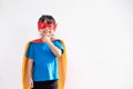 Kids concept, smiling girl playing super hero on white background Royalty Free Stock Photo