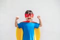 Kids concept, smiling girl playing super hero on white background Royalty Free Stock Photo