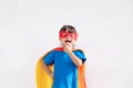 Kids concept, smiling girl playing super hero on white background Royalty Free Stock Photo