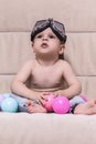 Kids Concepts. Little Caucasian Child In Aviator Goggles Posing Indoors While Sitting on Sofa