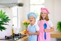 Kids cook in white kitchen. Children cooking Royalty Free Stock Photo