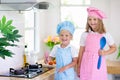 Kids cook in white kitchen. Children cooking Royalty Free Stock Photo