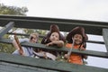 Kids In Costumes Looking Through Wooden Railings Royalty Free Stock Photo