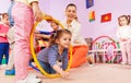 Kids crawl though hoop with teacher and friends Royalty Free Stock Photo