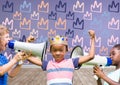 kids with crown with megaphones in blank room background with king crown graphics Royalty Free Stock Photo