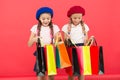 Kids cute schoolgirls hold bunch shopping bags. Children satisfied by shopping red background. Obsessed with shopping