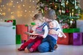 Kids in a dark room with a beautiful Christmas tree Royalty Free Stock Photo