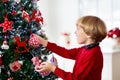 Kids decorate Christmas tree. Child on Xmas eve Royalty Free Stock Photo