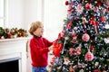 Kids decorate Christmas tree. Child on Xmas eve