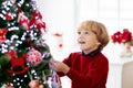 Kids decorate Christmas tree. Child on Xmas eve