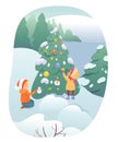 Kids decorate Christmas tree with festive decoration in snowy winter forest landscape Royalty Free Stock Photo