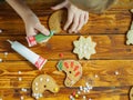 Kids decorate gingerbread cookies for the holiday