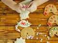 Kids decorate gingerbread cookies for the holiday