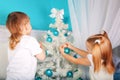 Kids decorating Christmas tree.