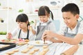 Kids decorating cookies. Royalty Free Stock Photo