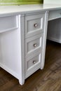 Kids desk with drawers. Classic children`s furniture in white color close-up