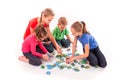 Kids of different age solving jigsaw puzzle together Royalty Free Stock Photo
